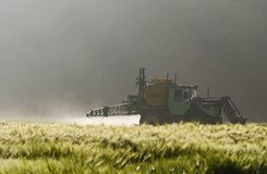 Tractor is spraying pesticides on a field